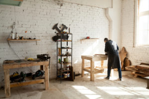 Man completing wood work project in his shed.